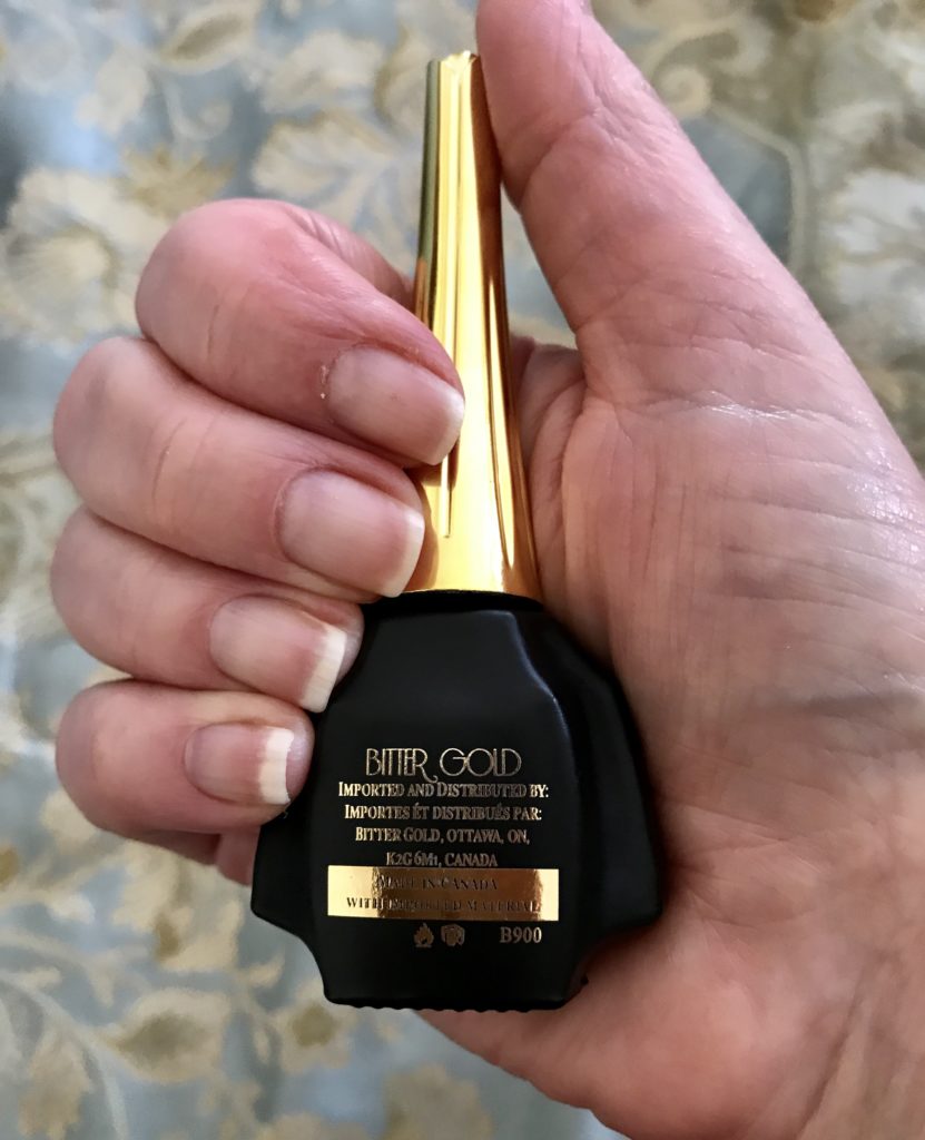 my hand and nails holding Bitter Gold, neversaydiebeauty.com