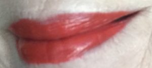 lip swatch of red-orange shade, Spicy Chili, from Clarins Joli Matte Velvet Lipstick, neversaydiebeauty.com