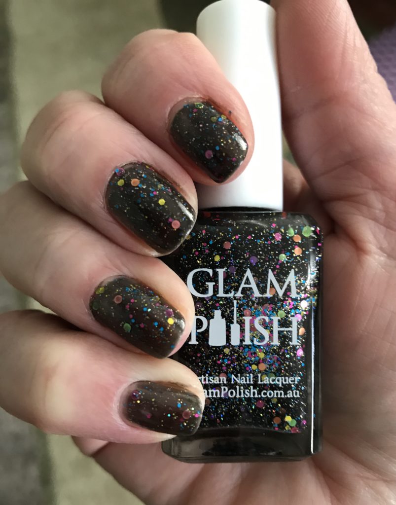 my nails wearing Glam Polish "We Will Rock You 2.0", a black crelly with lots of iridescent glitter and pastel round flakes, neversaydiebeauty.com