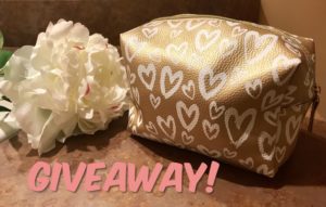metallic gold with white hearts large makeup bag filled with cosmetics for a giveaway, neversaydiebeauty.com