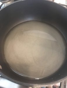 sugar and water combined in saucepan over heat, neversaydiebeauty.com