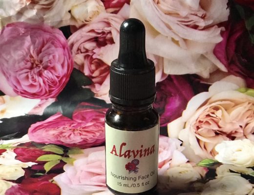 bottle of organic Alavina Nourishing Face Oil against a floral background, neversaydiebeauty.com