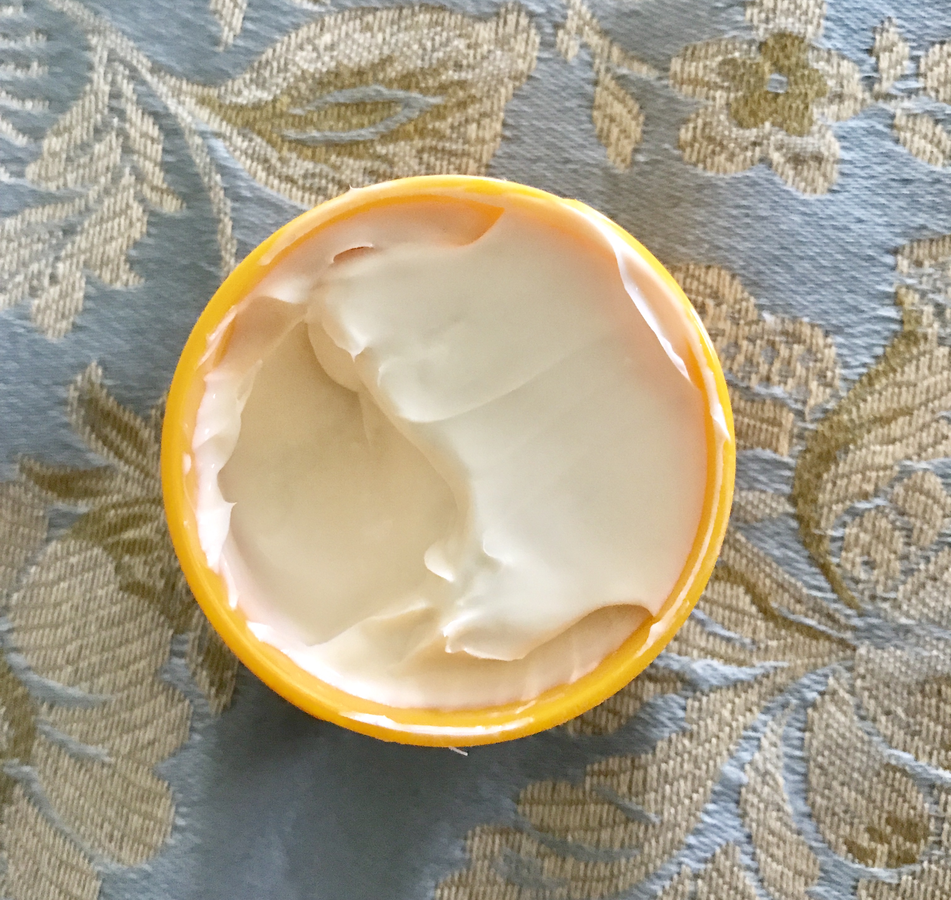 open jar of Sol de Janeiro Bum Bum Cream showing the thick off-white body cream, neversaydiebeauty.com