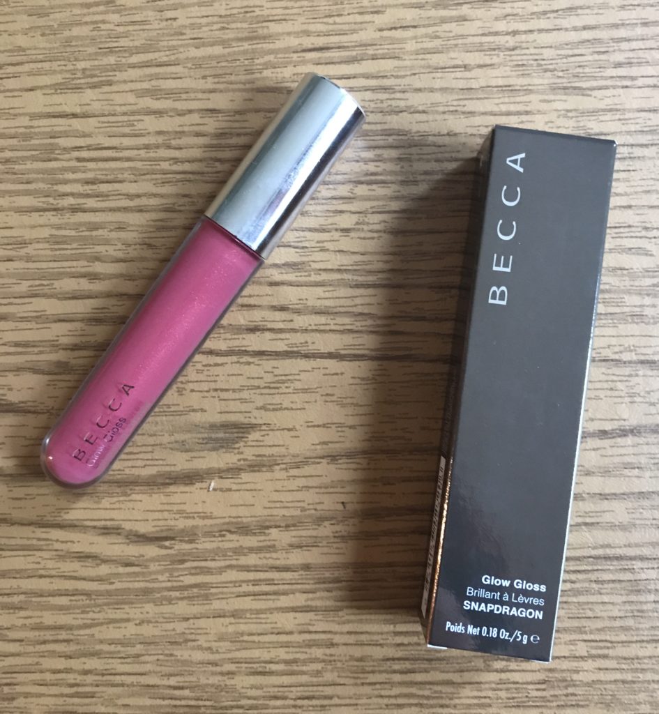 tube of pink Snapdragon BECCA Glow Gloss with the outer box it came in, neversaydiebeauty.com