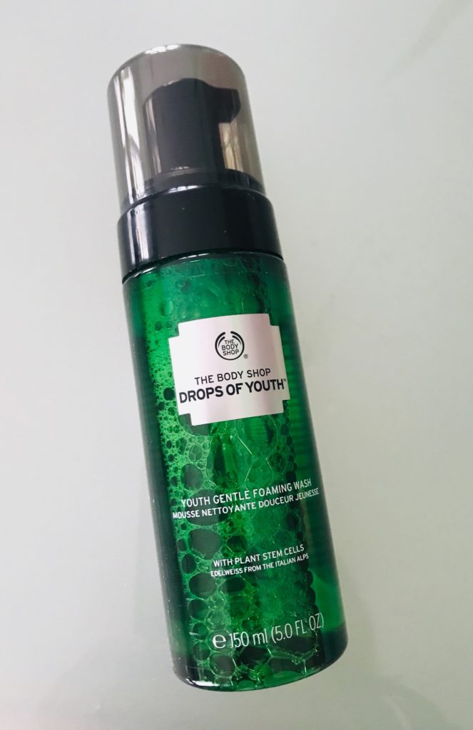 The Body Shop Drops of Youth Foaming Wash in a green translucent pump bottle