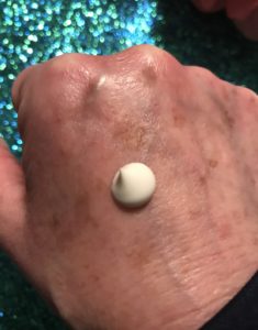 a blob of off-white Algenist Alive Prebiotic Balancing Moisturizer SPF 15 on the back of my hand to show the thickness