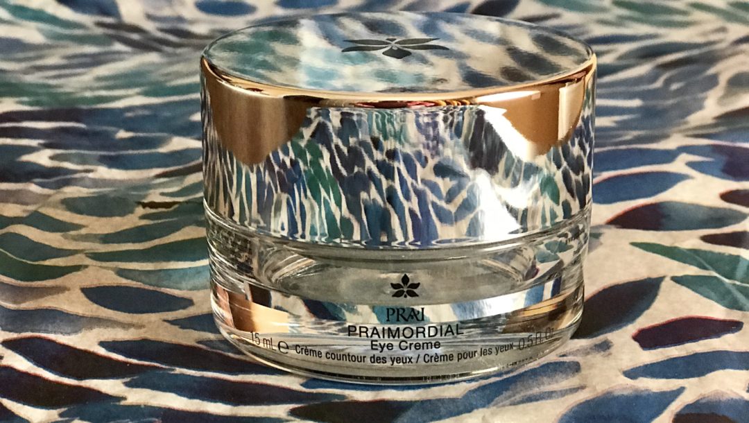 jar of PRAImordial Eye Creme against a patterned background, neversaydiebeauty.com