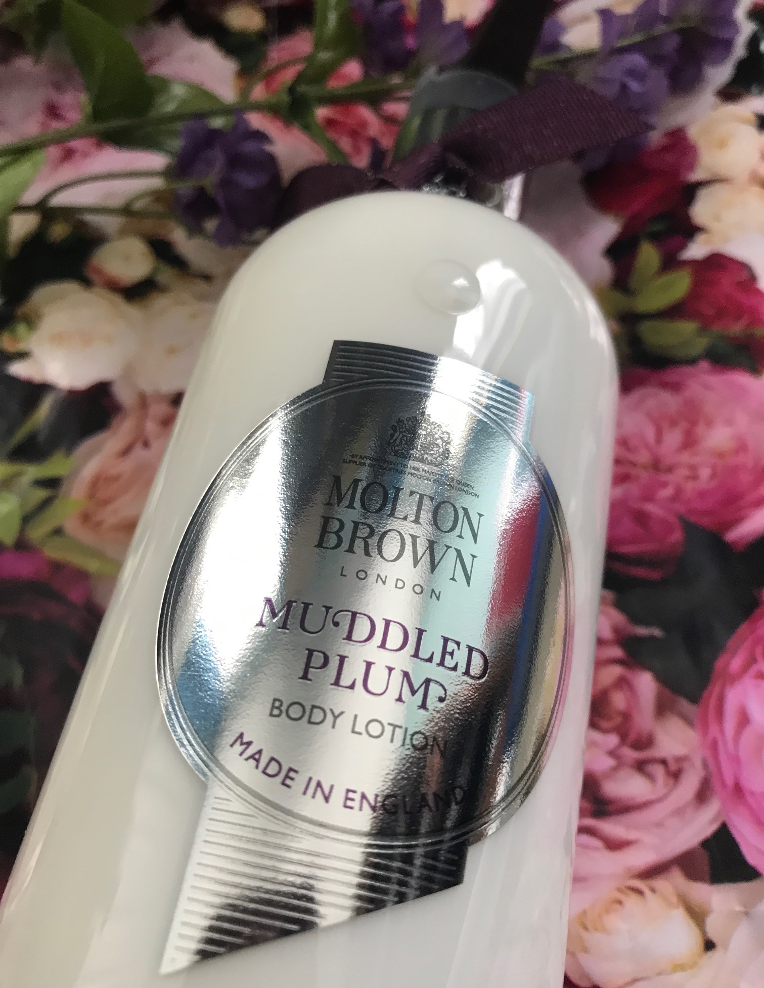 closeup of the label of the bottle of Molton Brown Muddled Plum Body Lotion, neversaydiebeauty.com