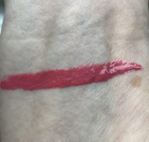 swatch of rosy pink Snapdragon shade of BECCA Glow Gloss, neversaydiebeauty.com