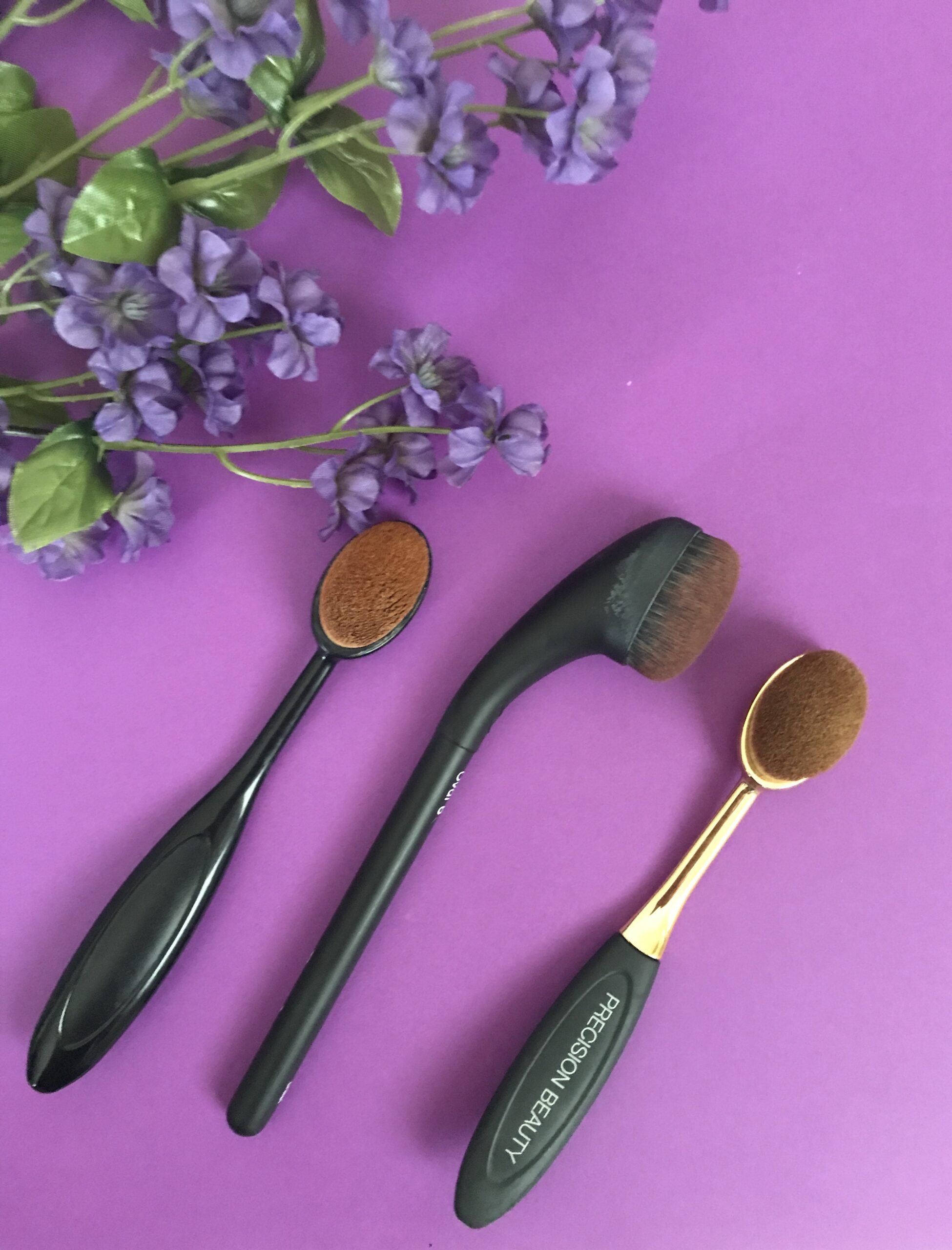 curved neck of the Artis Brushcraft Oval 6 makeup brush compared to two knockoffs that are more similar to the Artis Elite Oval 6, neversaydiebeauty.com