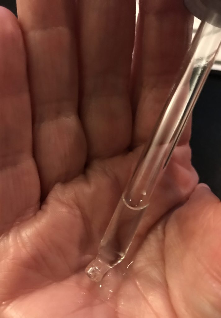 glass dropper containing clear liquid PRAI Glycolic Serum, neversaydiebeauty.com