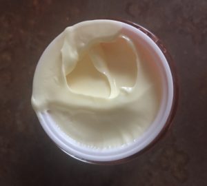 the pale yellow rich cream inside the jar of Sunday Riley CEO Vitamin C Cream, neversaydiebeauty.com