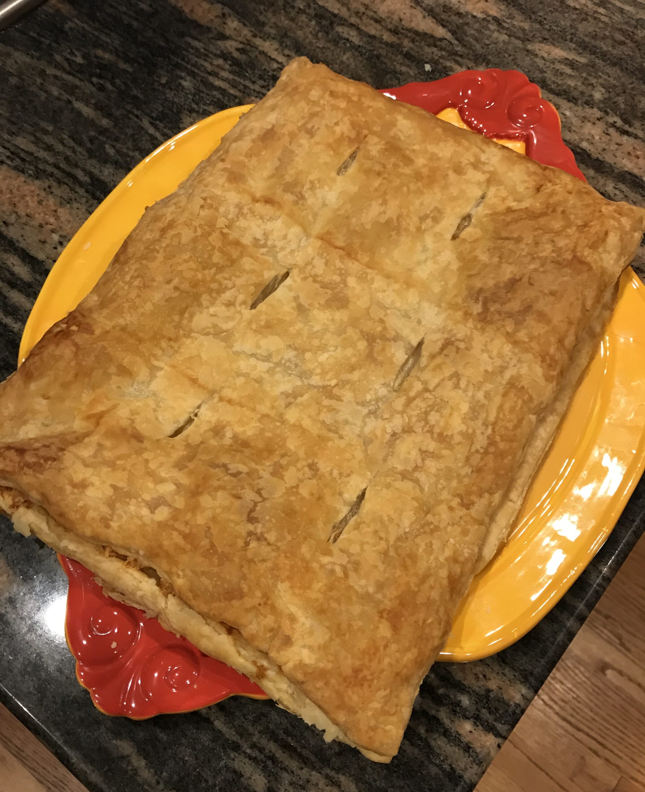 baked puff pastry appetizer on a serving platter, neversaydiebeauty.com