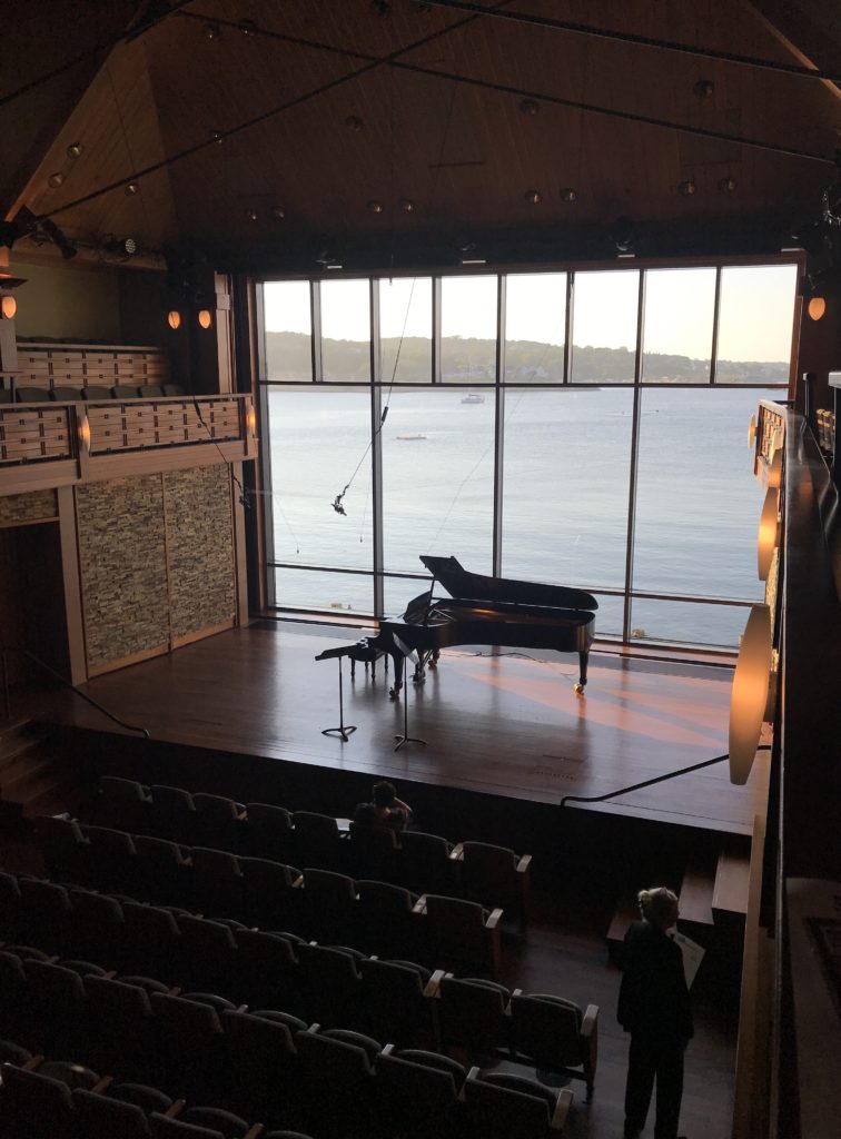 view of Rockport harbor from the huge window at the Shalin Liu concert hall in Rockport MA, neversaydiebeauty.com