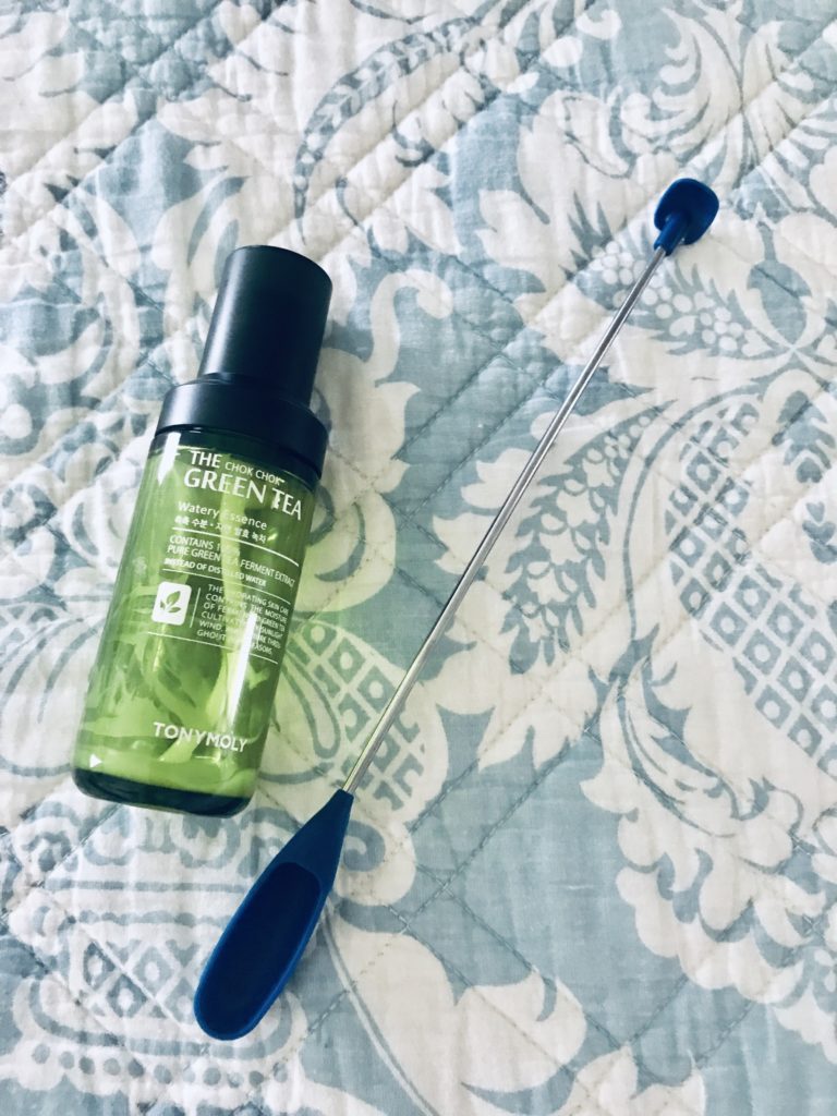 empty bottle of Tony Moly Green Tea Essence and double-ended silicone scoop