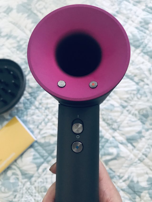 Dyson Supersonic Hairdryer showing the buttons to adjust the heat and speed