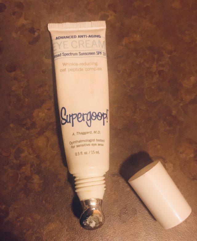 open tube of Supergoop Advanced Anti-aging Eye Cream SPF 37 open to show the metal applicator tip