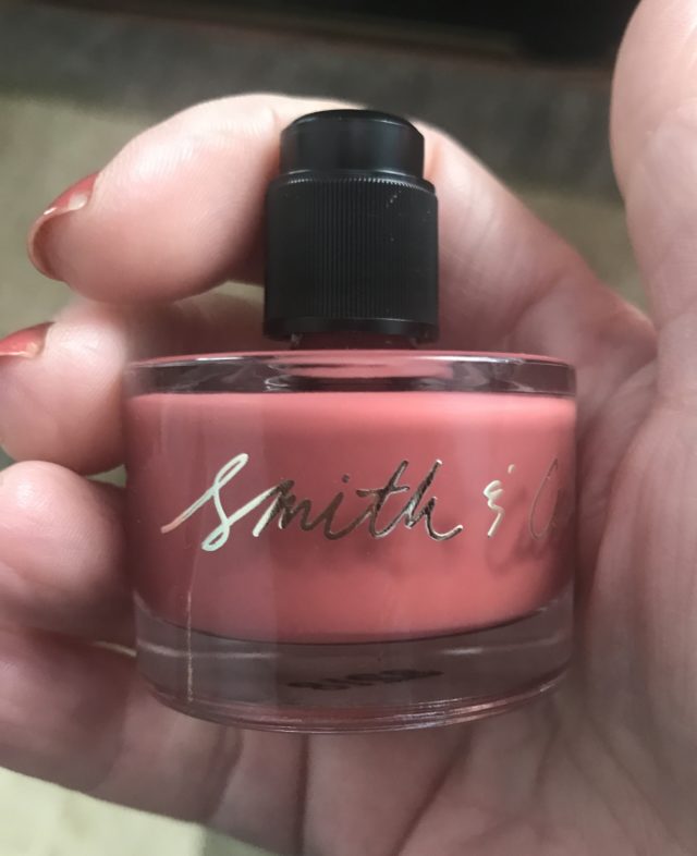small black top underneath the gold cap on the Smith & Cult nail polish bottle