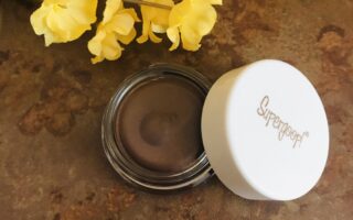 closeup of milk chocolate brown "Sunset", Supergoop Shimmershade Eyeshadow SPF 30 in its glass pot