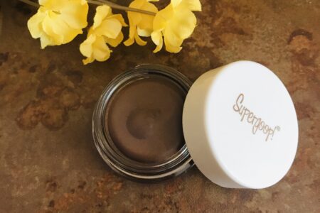 closeup of milk chocolate brown "Sunset", Supergoop Shimmershade Eyeshadow SPF 30 in its glass pot