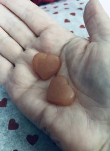 two heart-shaped biotin gummies in my hand