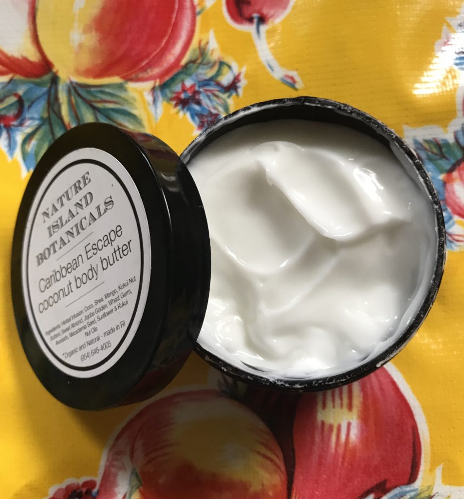 open jar of Nature Island Botanicals Caribbean Escape Body Butter showing the creamy white whipped body lotion