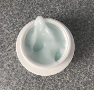 open jar of belif The True Cream Aqua Bomb showing the pale blue gel-cream