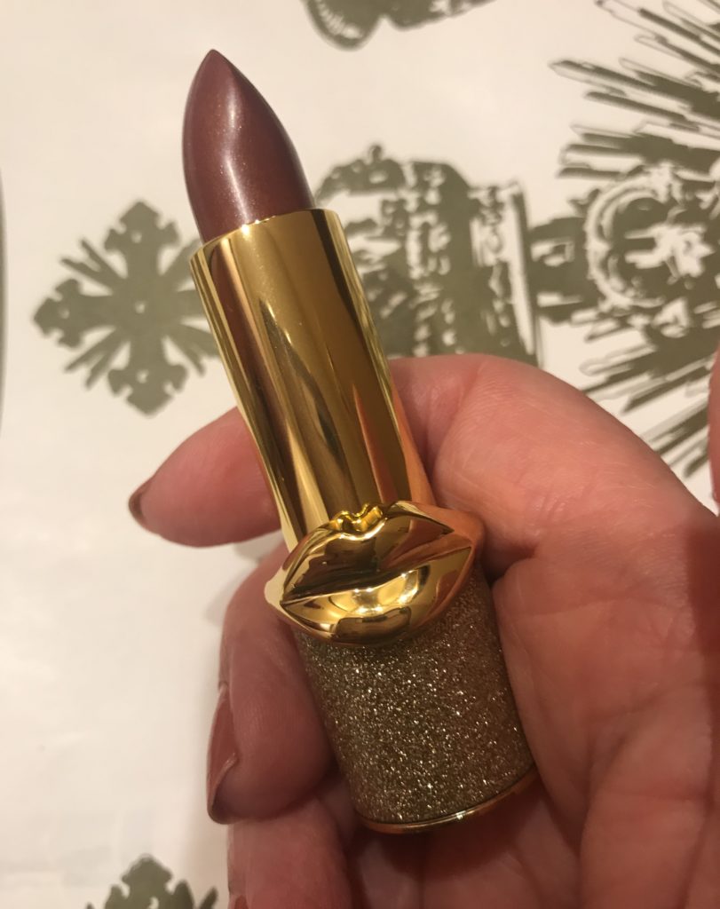 my hand holding Pat McGrath BlitzTrance lipstick with the bullet exposed to show the shade, Flesh 3