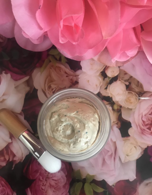 open jar of Zoe Antioxidant-Rich Face Mask showing the pale yellow mask with green vitamin E beads and applicator brush