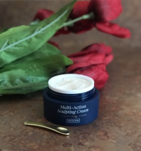 open jar of City Beauty Multi-Action Sculpting Cream with golden scoop