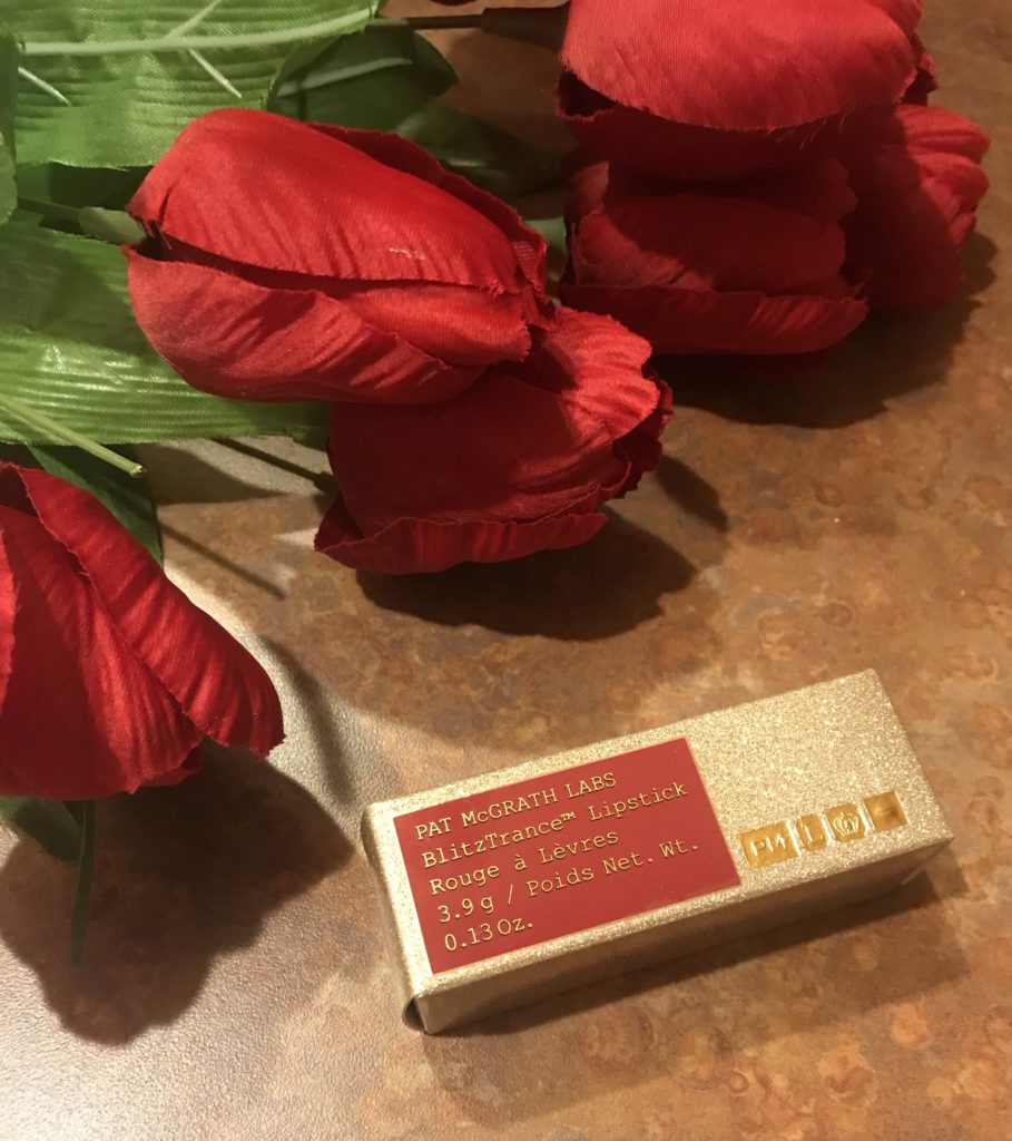 golden holographic glitter adorned outer box for Pat McGrath BlitzTrance lipstick 