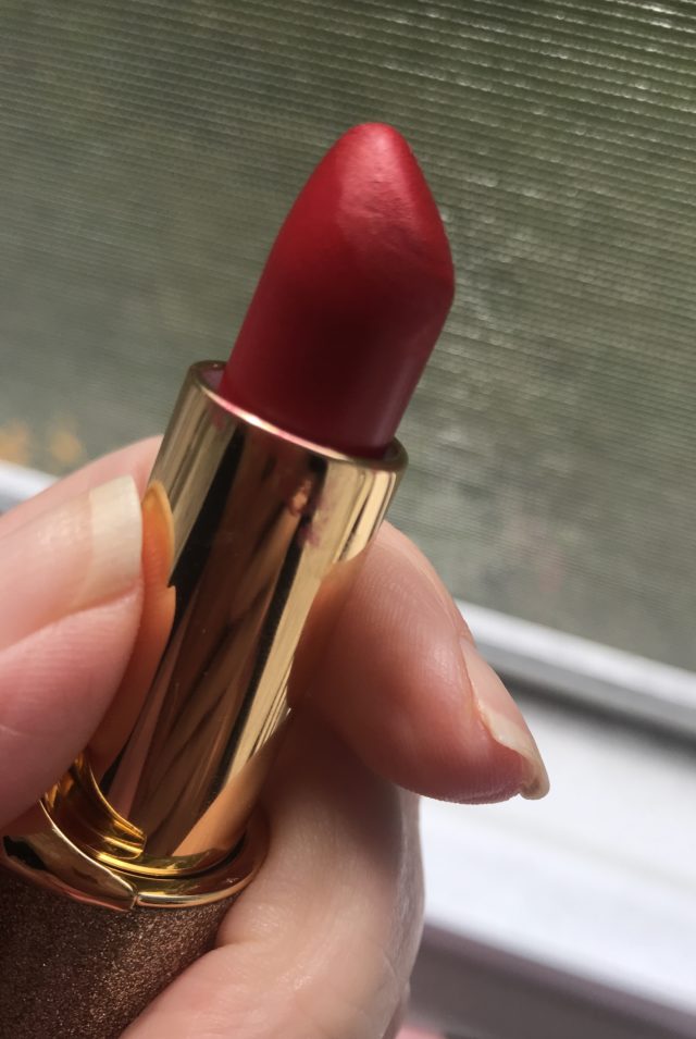 Pat McGrath BlitzTrance lipstick in shade Blood Rush, with the bullet showed near the window so you can see the shade