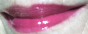 lip swatch of Berry Blessed , hot pink shade in direct sunlight, from Revlon Ultra HD Vinyl Lip Polish