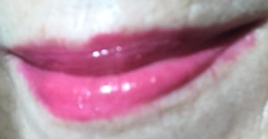 my lips wearing Berry Blessed shade of Revlon Ultra HD Lip Polish after eating 