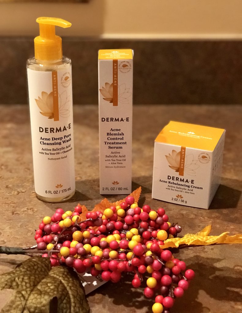 3 Derma E Acne treatment skincare products in their outer boxes: Cleansing Wash, Serum and Rebalancing Cream