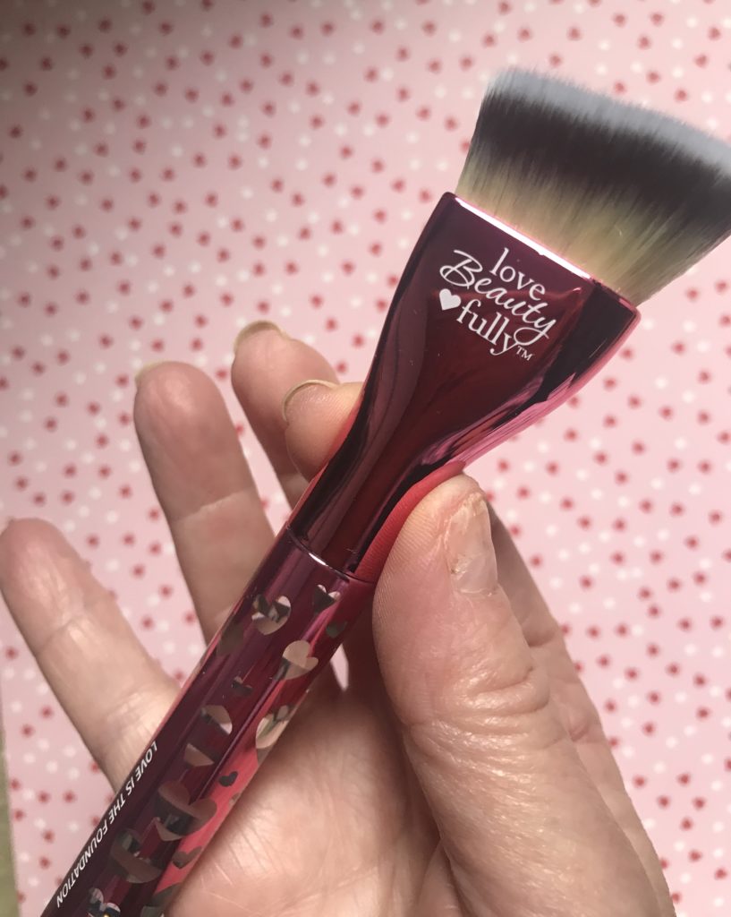 closeup of heart adorned handle of IT for Ulta Love Is the Foundation brush for Breast Cancer Awareness Month October 2019