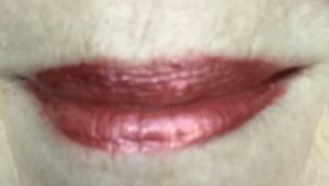 lip swatch of metallic coral Sephora Collection Cream Lip Shine in shade 30 Frosted Peach