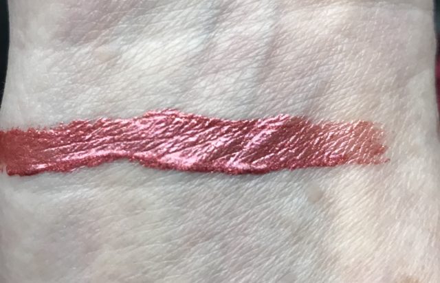 swatch on my arm of Sephora Collection Cream Lip Shine, shade 30 Frosted Peach, a metallic coral