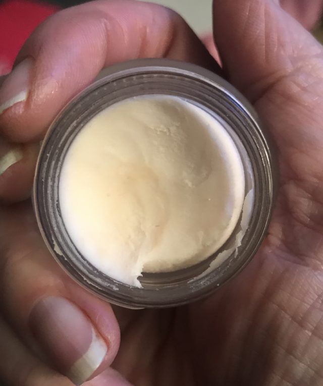 closeup of the pale pink thick cream in the open travel size jar of Tarte Timeless Smoothing Primer