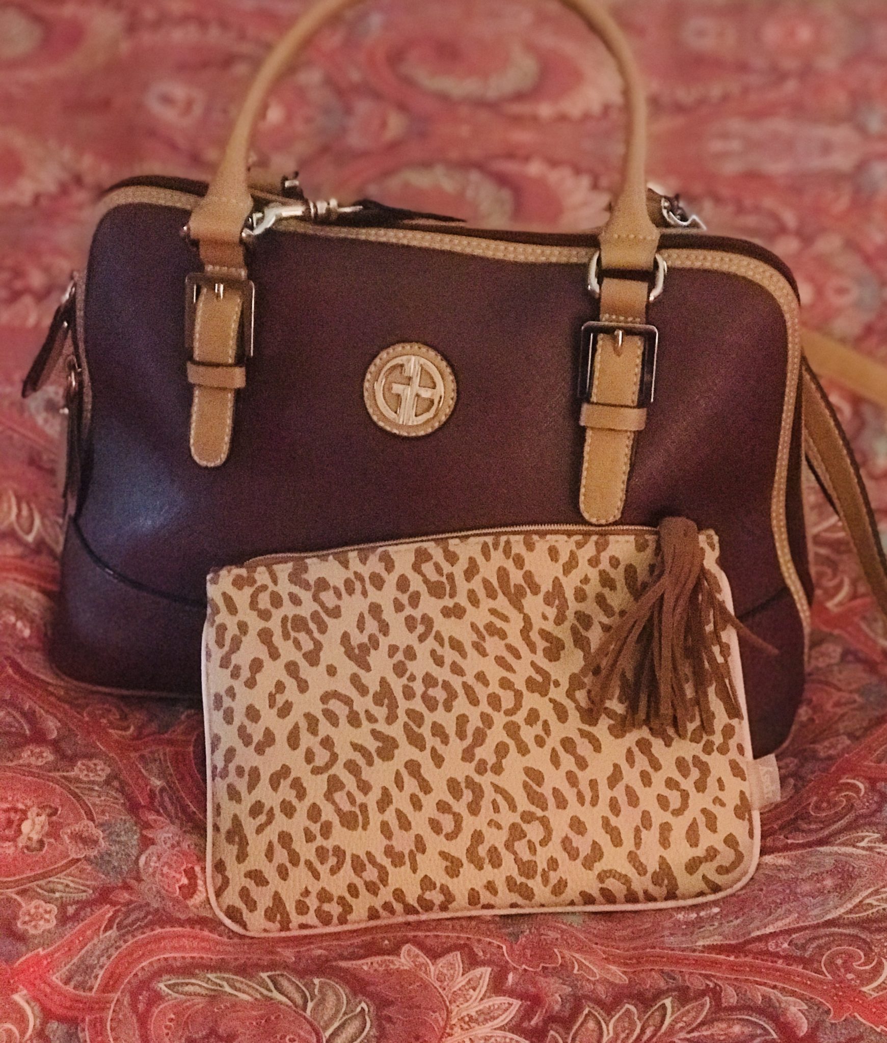 leopard print makeup bag with faux suede tassel with my purple purse with caramel trim that matches the makeup bag