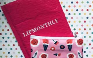 bright pink Lip Monthly mailer and pink pattern makeup bag for December 2019