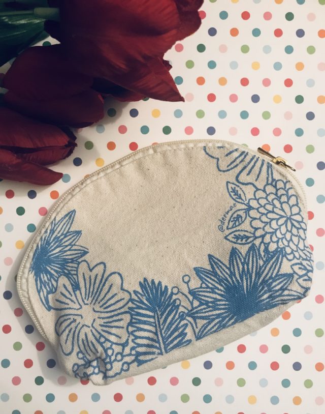 natural cotton makeup bag with blue stylized flowers that is part of the Derma E Perfect Travel Kit