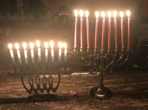 two menorahs lit with all the candles