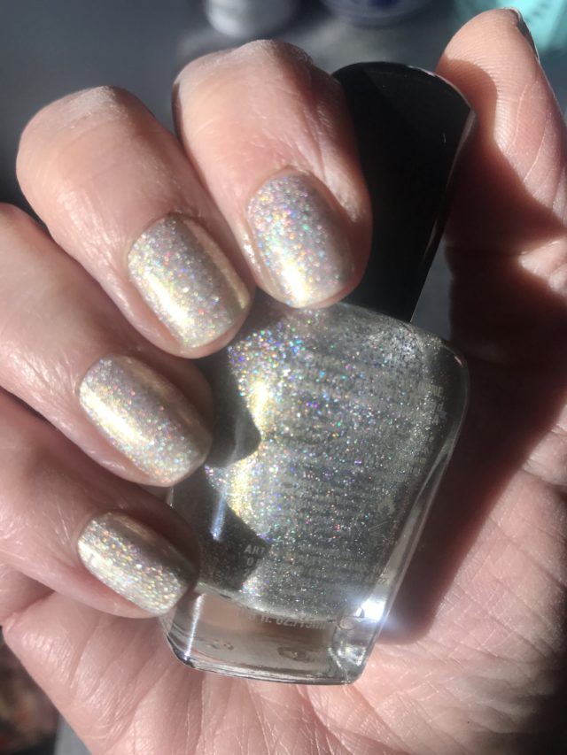 my nails wearing silver linear holo Alicia and holding the bottle