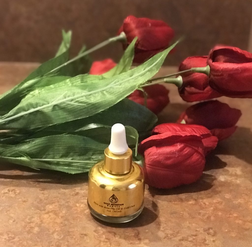 gold bottle of Gold Mountain Elixir of Rose Hip Oil and Gold Dust