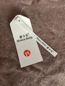 hang tag on Chinese cashmere sweater that identifies "Menca Sheep"