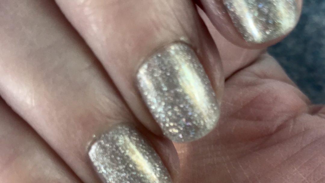 my nails wearing silver holo with a touch of gold, sparkly Alicia from Zoya