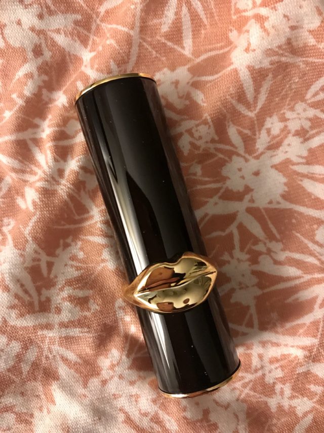 black metal tube with gold accents and gold lips
