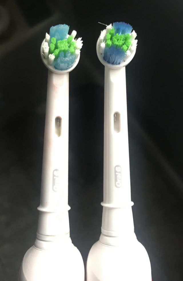 two brush heads for the Oral B Advanced Clean Electric Toothbrush: one that I have been using for 6 weeks where the blue bristles have faded somewhat in color vs. the deep blue bristles of the unused brush head