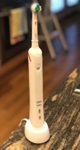 Oral B Advanced Clean Power Rechargeable Electric Toothbrush in its charging stand